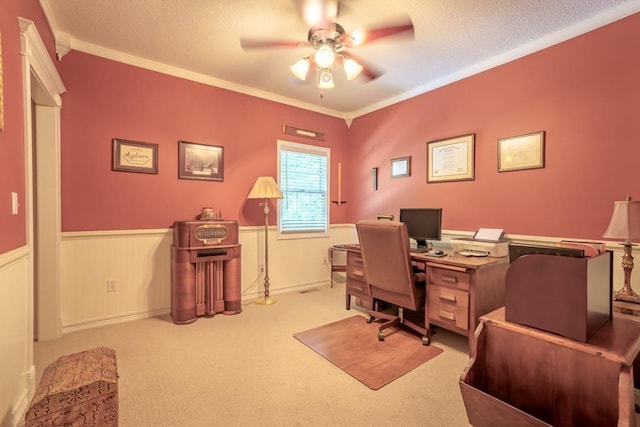 office space featuring a textured ceiling, ceiling fan, ornamental molding, and light carpet