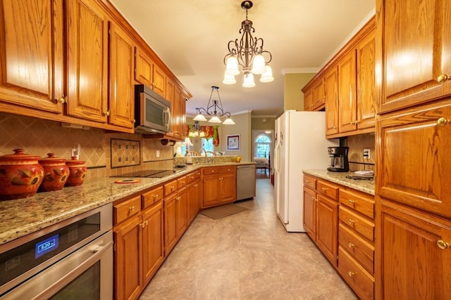 kitchen with a notable chandelier, crown molding, pendant lighting, decorative backsplash, and appliances with stainless steel finishes