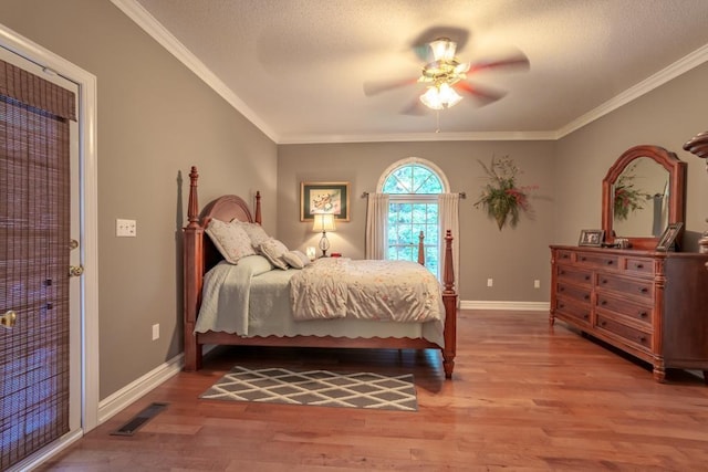 bedroom with hardwood / wood-style floors, ceiling fan, and ornamental molding