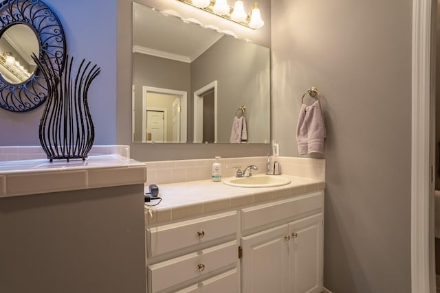 bathroom with crown molding and vanity