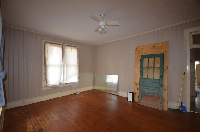 unfurnished living room featuring ceiling fan, dark hardwood / wood-style flooring, and ornamental molding