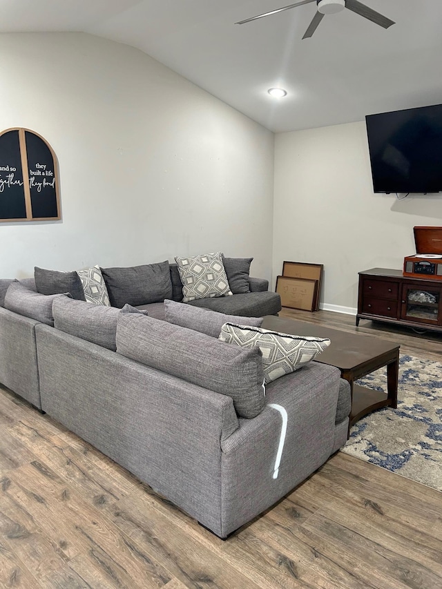 living room with lofted ceiling, wood finished floors, and a ceiling fan