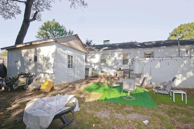 rear view of house featuring a yard