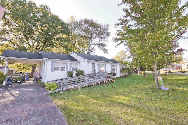 exterior space with a front lawn and a carport