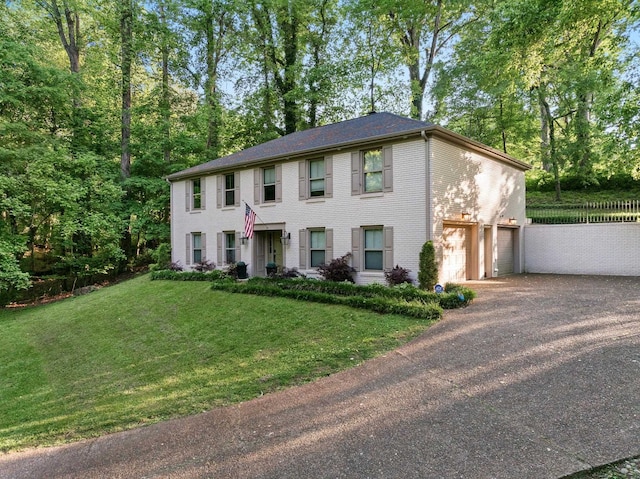 colonial house featuring an attached garage and driveway