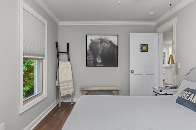 bedroom with dark wood-style flooring, crown molding, and baseboards
