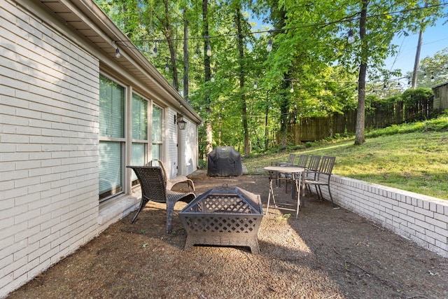 view of patio / terrace with grilling area and a fire pit