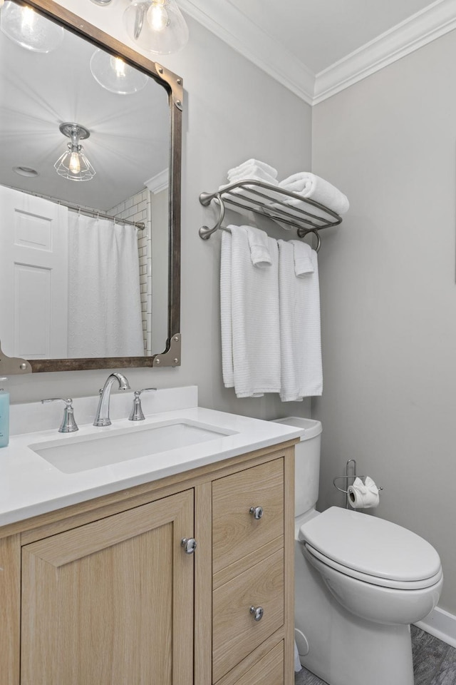 bathroom featuring ornamental molding, toilet, and vanity