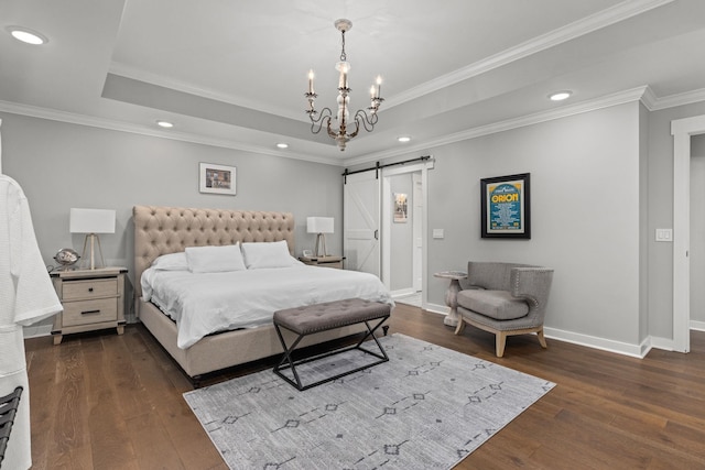 bedroom with a barn door, a tray ceiling, wood-type flooring, baseboards, and recessed lighting
