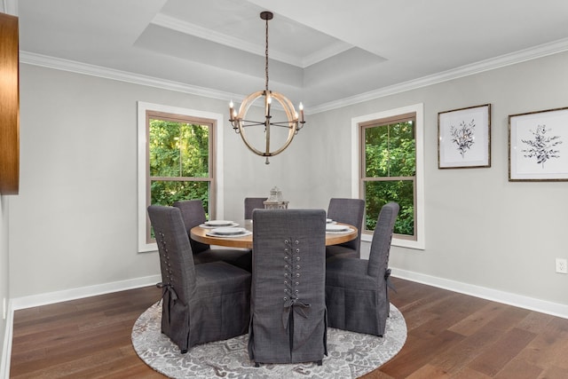 dining area featuring a chandelier, healthy amount of natural light, wood finished floors, ornamental molding, and baseboards