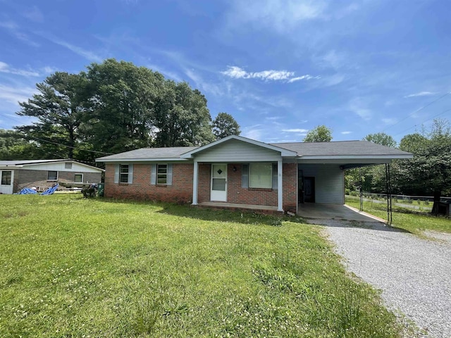  - single story home with gravel driveway, an attached carport, and brick siding