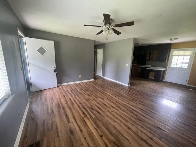  - unfurnished living room with dark wood finished floors, ceiling fan, and baseboards