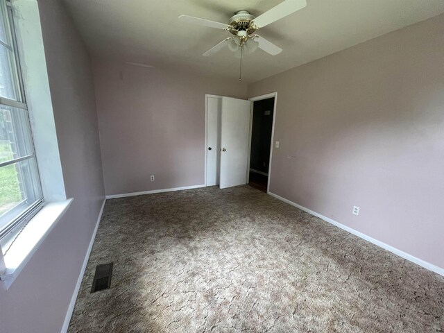  - unfurnished room featuring carpet flooring, baseboards, and ceiling fan
