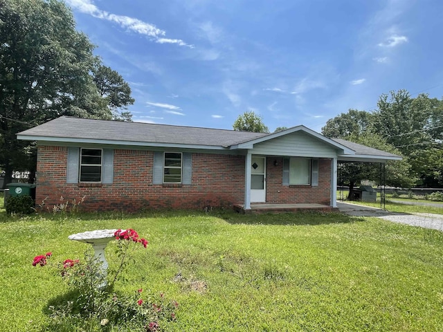  - single story home featuring brick siding, a front lawn, driveway, and covered porch