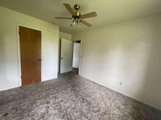  - unfurnished bedroom featuring carpet, baseboards, and ceiling fan