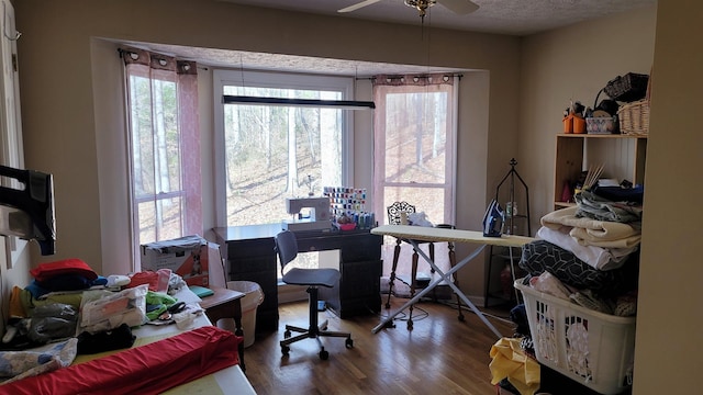 office space featuring ceiling fan, hardwood / wood-style floors, and a textured ceiling