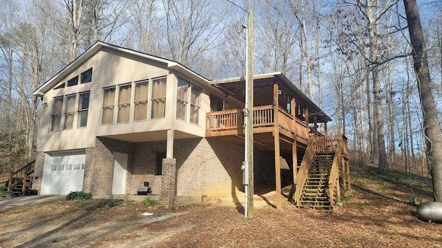 back of house with a sunroom and a garage