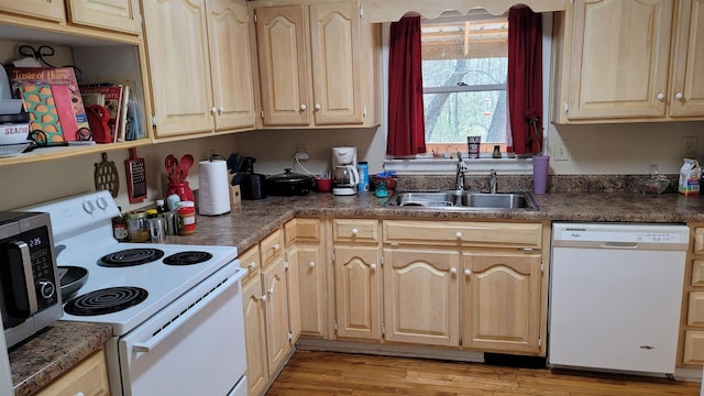 kitchen featuring light brown cabinetry, white appliances, light hardwood / wood-style floors, and sink