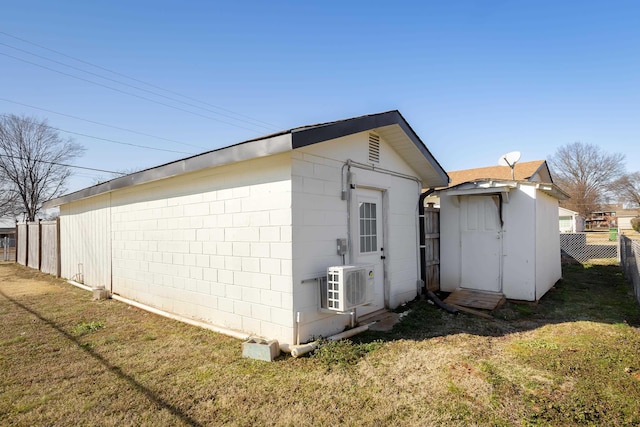 view of side of home featuring ac unit and a lawn