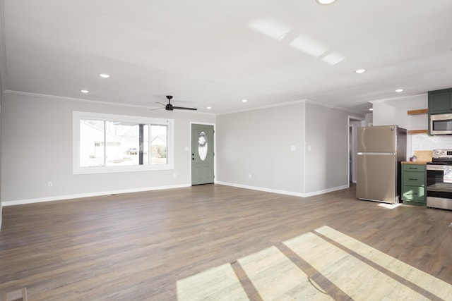 unfurnished living room featuring hardwood / wood-style flooring, ceiling fan, and ornamental molding