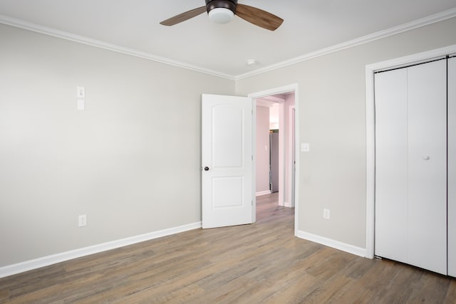 unfurnished bedroom featuring wood-type flooring, ornamental molding, a closet, and ceiling fan