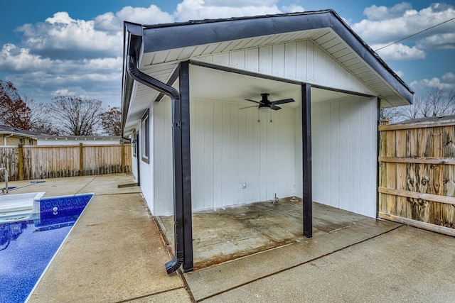 exterior space featuring ceiling fan and a fenced in pool