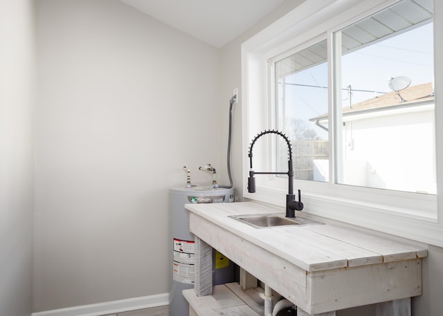 interior space featuring electric water heater and sink