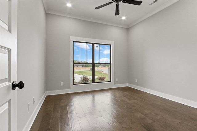 spare room featuring dark hardwood / wood-style flooring, ceiling fan, and ornamental molding