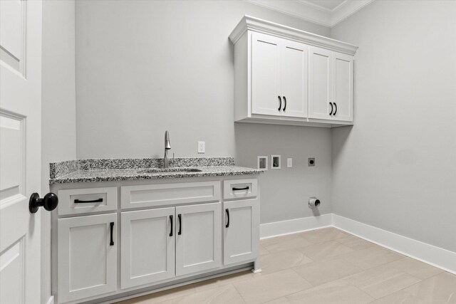 washroom with hookup for an electric dryer, hookup for a washing machine, cabinets, ornamental molding, and sink