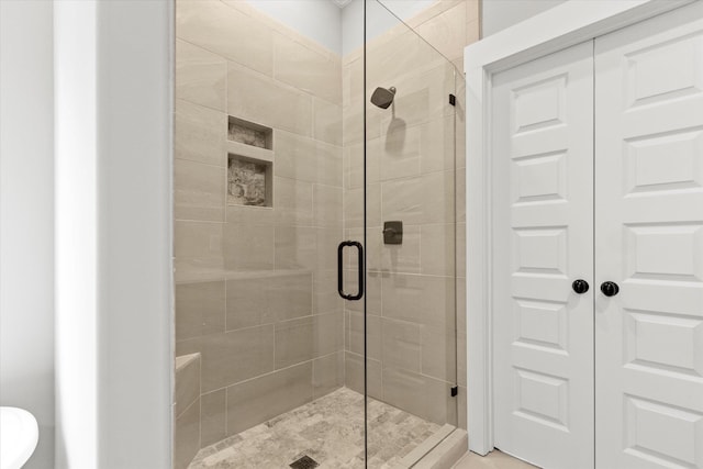 bathroom featuring a shower with door