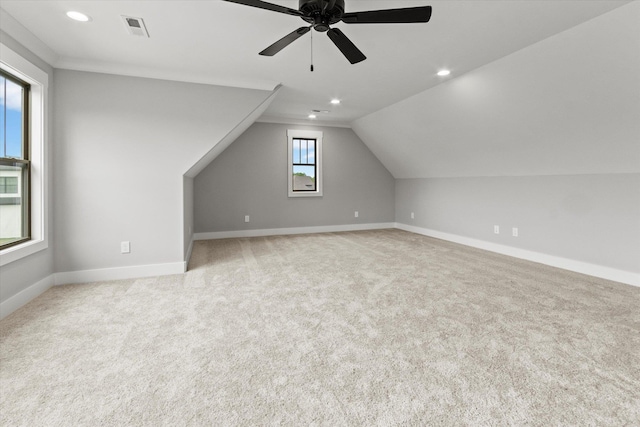 bonus room with ceiling fan, light carpet, and lofted ceiling