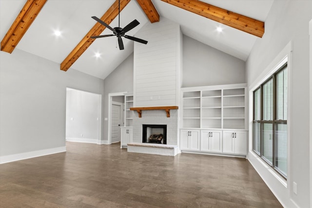 unfurnished living room featuring dark hardwood / wood-style flooring, a brick fireplace, ceiling fan, beam ceiling, and high vaulted ceiling