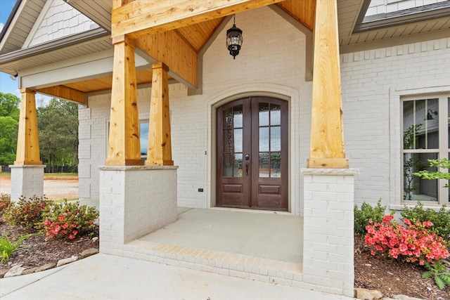 doorway to property featuring french doors and covered porch