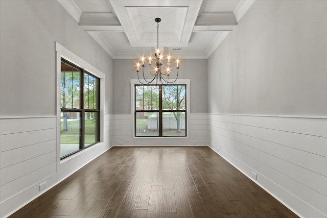 unfurnished room with coffered ceiling, crown molding, beamed ceiling, a notable chandelier, and dark hardwood / wood-style flooring