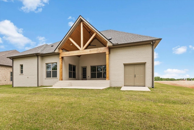 rear view of property featuring a lawn