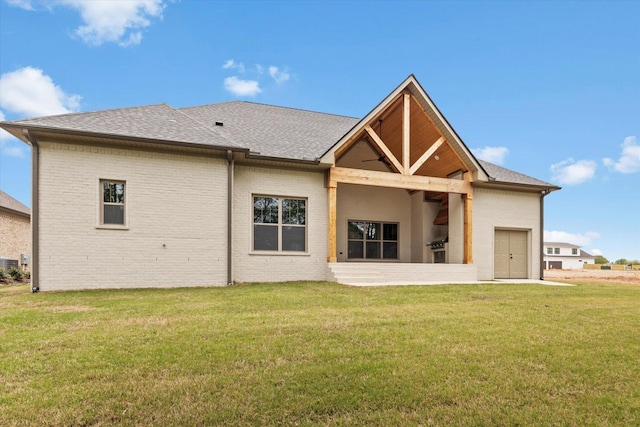 rear view of house with a yard