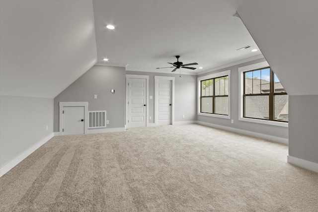 additional living space with ceiling fan, carpet floors, and lofted ceiling