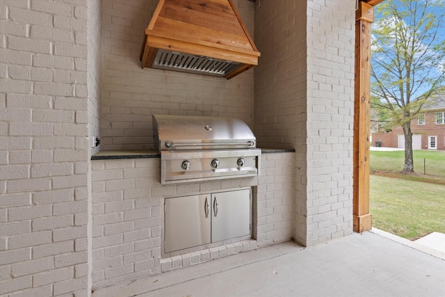 view of patio featuring exterior kitchen and a grill