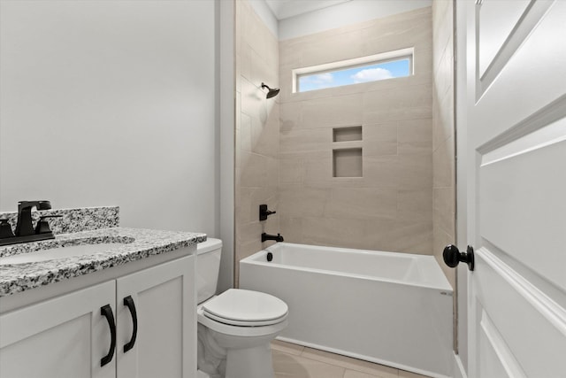 full bathroom featuring tile patterned flooring, tiled shower / bath combo, toilet, and vanity