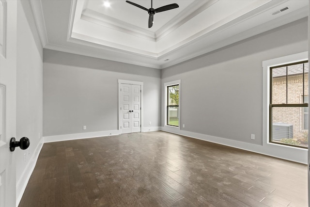 spare room featuring a raised ceiling, ceiling fan, wood-type flooring, and ornamental molding