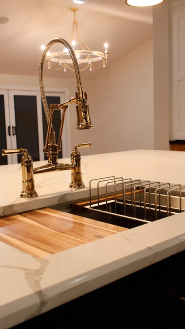 interior details featuring a notable chandelier and sink