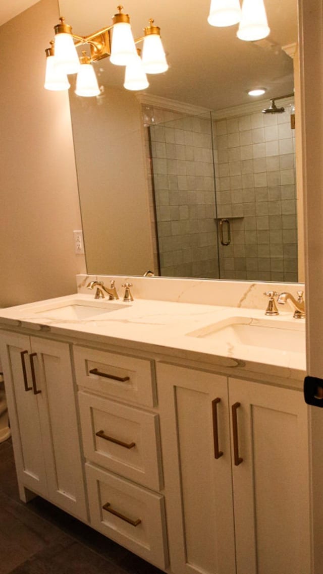 bathroom featuring vanity, an inviting chandelier, and walk in shower