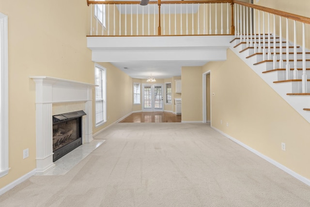 unfurnished living room featuring light colored carpet