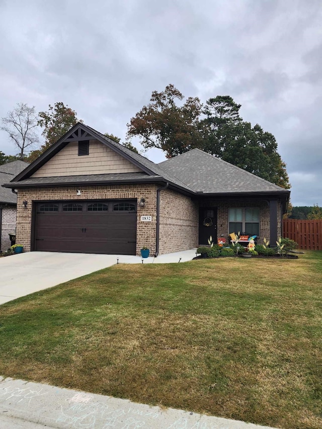 view of front of property featuring a garage and a front yard