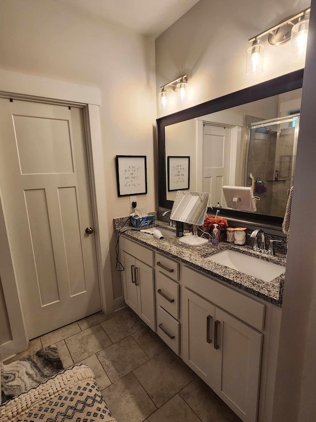 bathroom featuring vanity and a shower with door