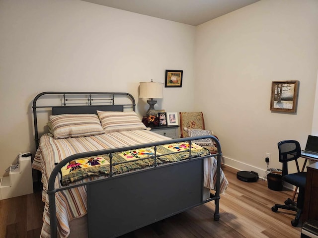 bedroom with wood-type flooring