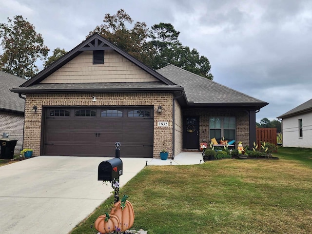 view of front of property featuring a front lawn and a garage