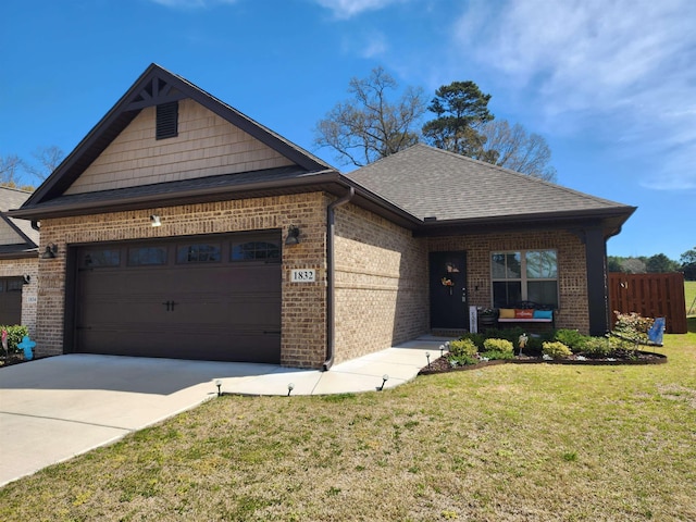 view of front of home featuring brick siding, a front yard, roof with shingles, and an attached garage