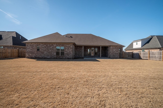 rear view of house with a patio area and a yard