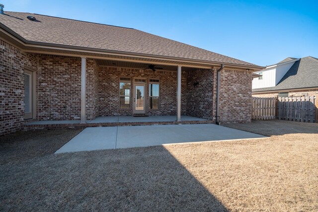 doorway to property with ceiling fan and a patio